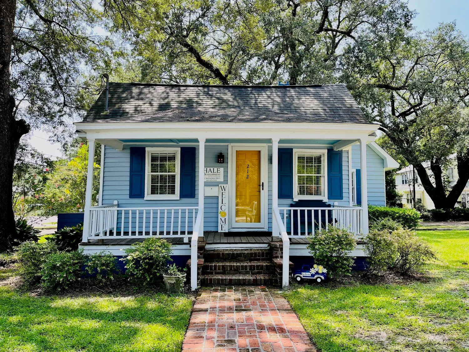 Restored blue historic cottage that serves as the Hale Development office at 212 E 1st N St in Summerville, SC